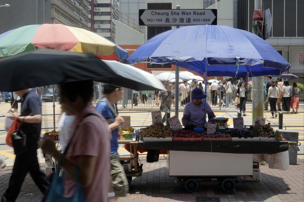 Ninety-two-year-old licensed hawker Chan Tak-ching tends to her stall in Hong Kong’s Lai Chi Kok district on July 7. Hong Kong should heed calls to revamp its rules governing hawker licences. Photo: Sun Yeung