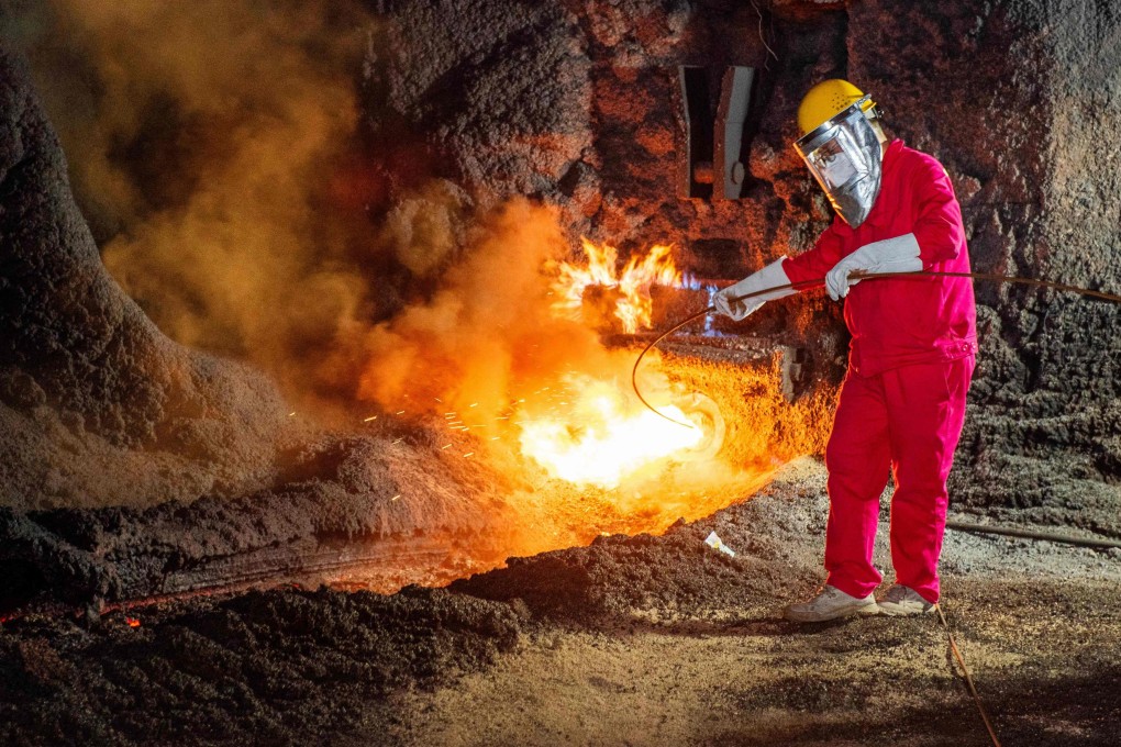 A worker stands by a stream of molten steel at a steel factory in Huaian, in eastern Jiangsu province, on July 22. Photo: AFP