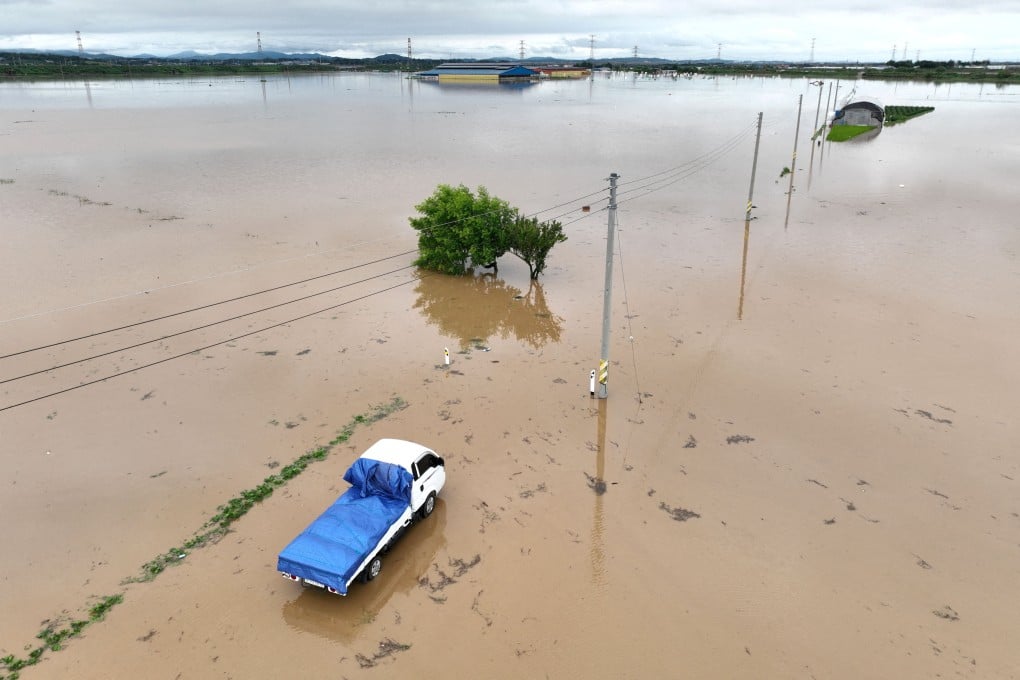 A flooded road caused by torrential rain in Yesan, South Korea. Photo: Yonhap via Reuters