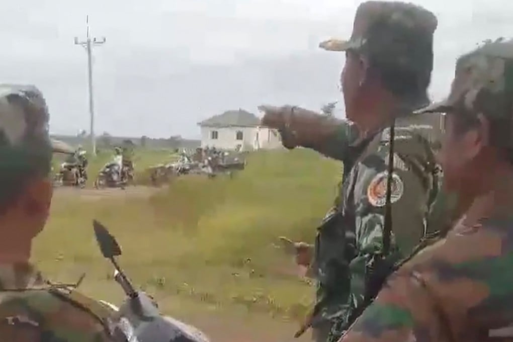 Cambodian soldiers in Preah Vihear province point at people evacuating the area along the border with Thailand after troops exchanged fire in a new round of clashes on Thursday. Photo: AFP