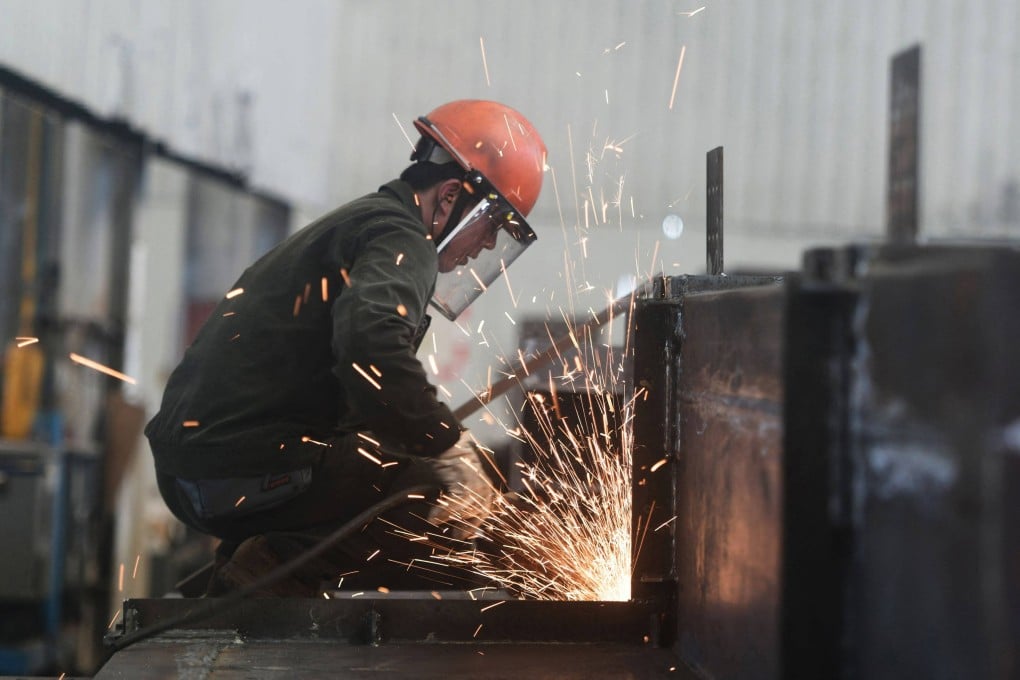 An employee works at a factory which produces steel structures in Hangzhou, in Zhejiang province, on July 15. China’s economy grew by 5.2 per cent in the second quarter of the year, official data showed, matching forecasts as strong exports helped it withstand trade war pressures. Photo: AFP