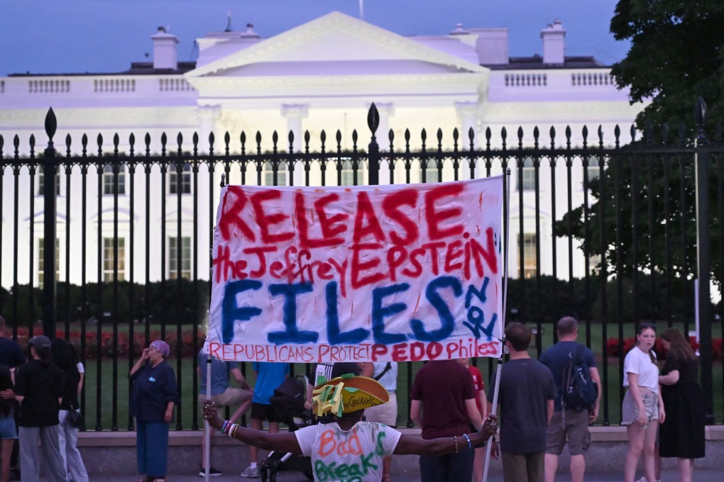 A protester holds a sign outside the White House on Friday demanding the release of the Epstein files. Photo: TNS