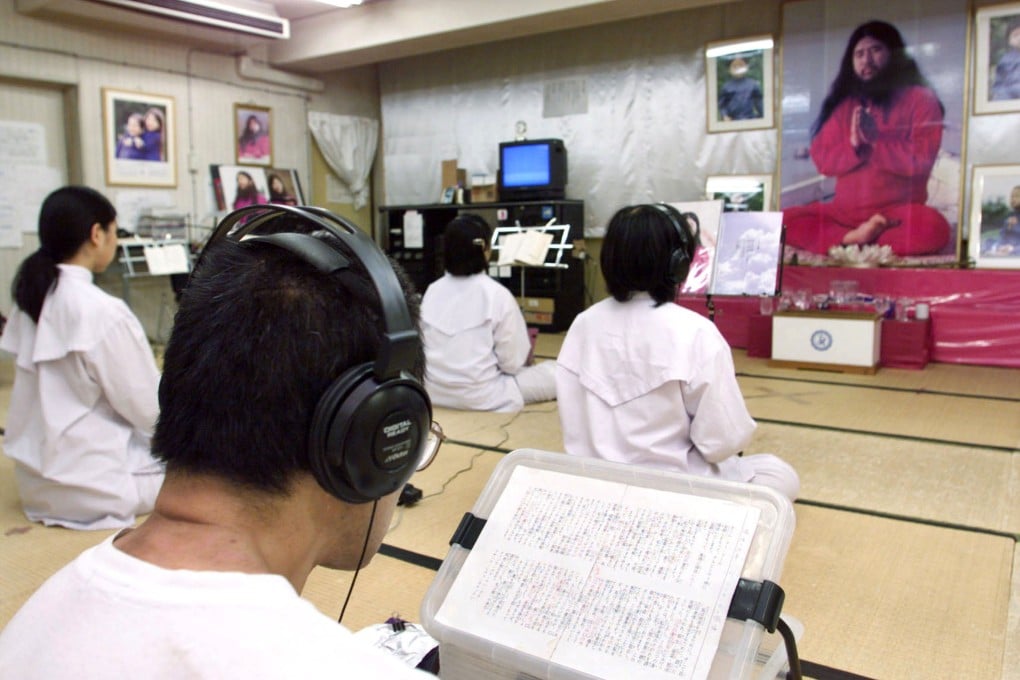 Followers of the Aum Shinrikyo doomsday cult chant before a portrait of cult leader Shoko Asahara in Tokyo, Japan, in 1999. Photo: Reuters