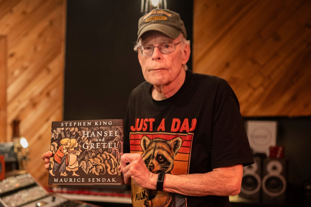 Author Stephen King holds up a copy of his retelling of the Grimm fairy tale Hansel and Gretel on April 23. Photo: HarperCollins via AP