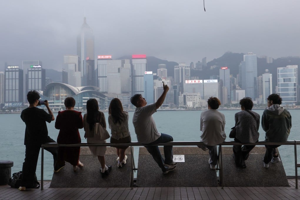 Tourists look at Victoria Harbour from Tsim Sha Tsui. Photo: Dickson Lee