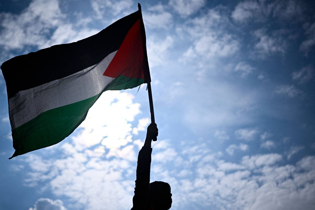 A protester holds a Palestinian flag during a rally called by several French organisations in Paris in May 2024. Photo: AFP