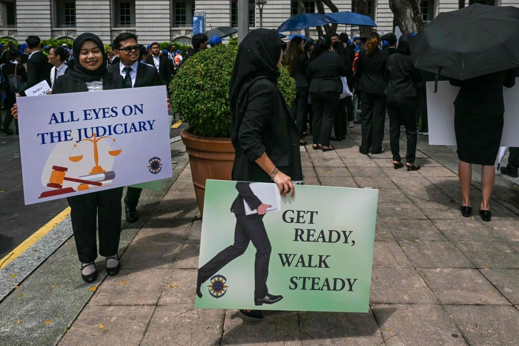 Malaysian Bar Council members hold placards during a rally near the prime minister’s office in Putrajaya on July 14 to protest against the delay in appointing the country’s top judges. Photo: AFP