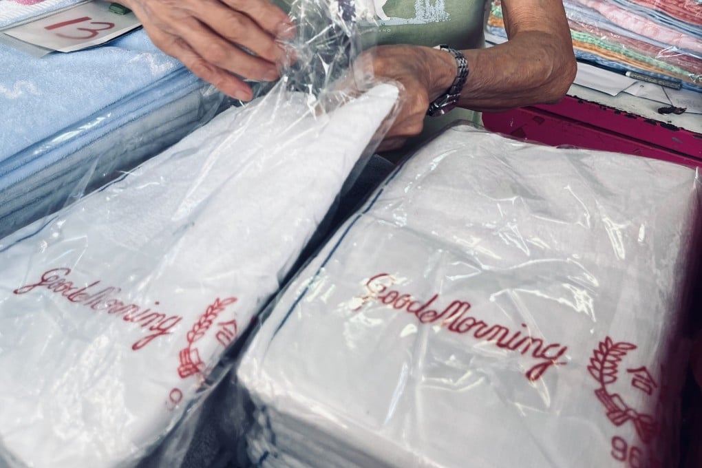 A woman sells Good Morning towels at a stall in Hong Kong’s Sham Shui Po district on July 19, 2025. Photo: Kylie Knott