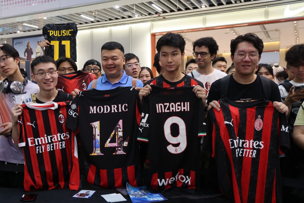 AC Milan fans holding player jerseys outside a Puma store at Kai Tak Mall 2 on Friday. Photo: Jelly Tse