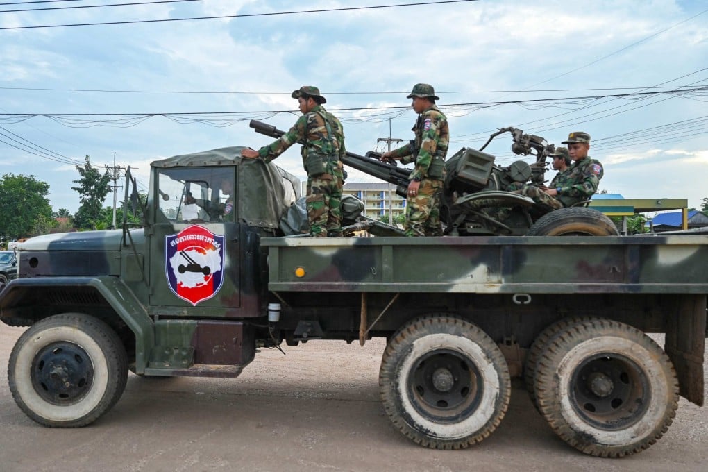 Cambodian soldiers stand on a military truck with an anti-aircraft gun in Oddar Meanchey province on Friday. Photo: AFP