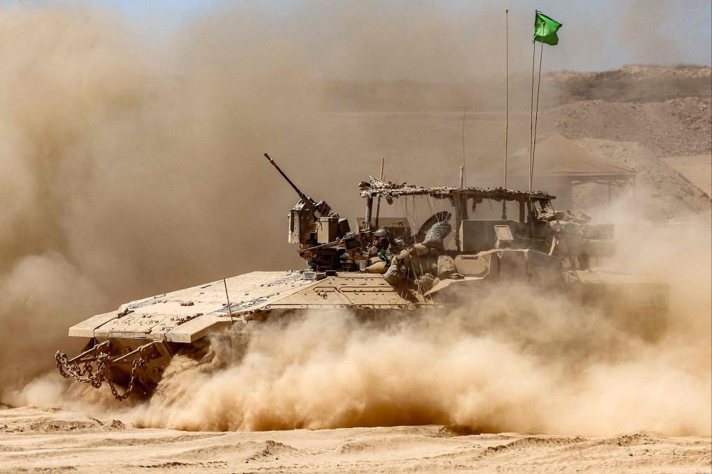 A cloud of dust is seen as an Israeli army infantry fighting vehicle moves at a position along the border with the Gaza Strip on Wednesday. Photo: AFP