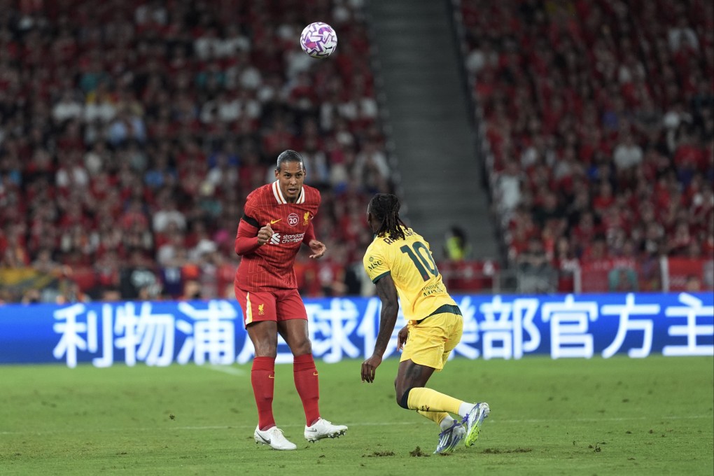 Liverpool’s Virgil van Dijk heads the ball during the match against AC Milan. Photo: Elson Li