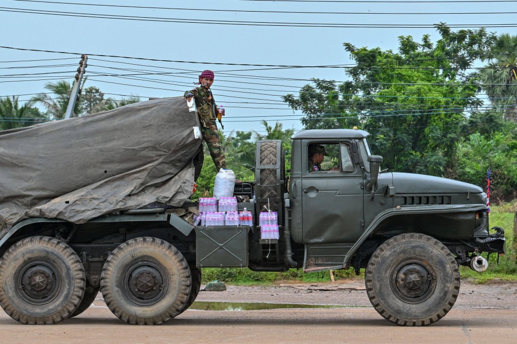 A Cambodian soldier stands on a truck carrying a Russian-made BM-21 rocket launcher travelling along a street in Oddar Meanchey province on Saturday, the third day of border clashes with Thailand. Photo: AFP