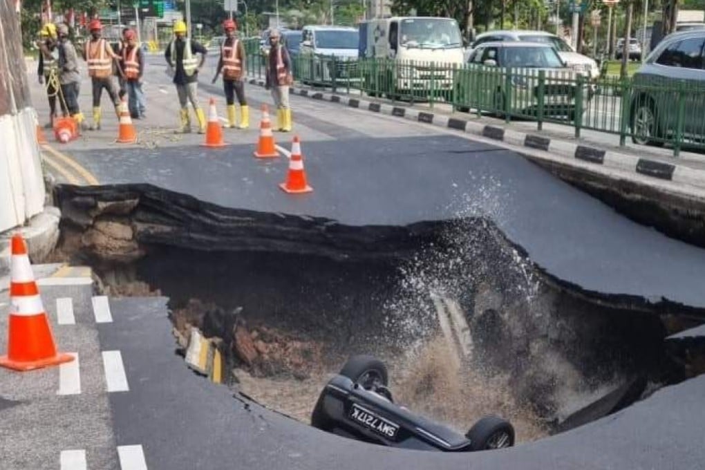 A Mazda plunged into a sinkhole along Tanjong Katong Road in Singapore on Saturday evening. Photo: Facebook/Safety WatchSG