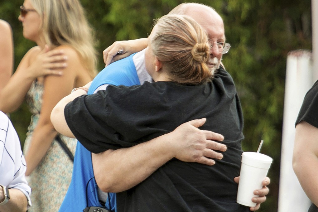 Walmart employees and customers wait outside while police investigate the scene after a stabbing in Traverse City, Michigan on Saturday. Photo: Traverse City Record-Eagle / AP