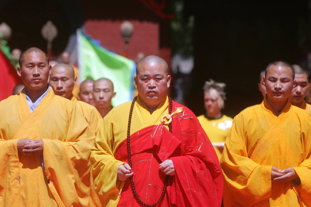 Shi Yongxin (centre), abbot of the Shaolin Temple in central China, is under joint investigation by multiple departments. Photo: Getty Images