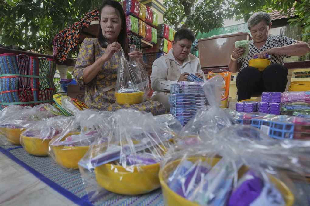 Chadaporn Duchanee (left) and friends pack goods for Thai residents who fled homes following clashes between Thai and Cambodian soldiers in Surin province, Thailand, on Friday. Photo: AP