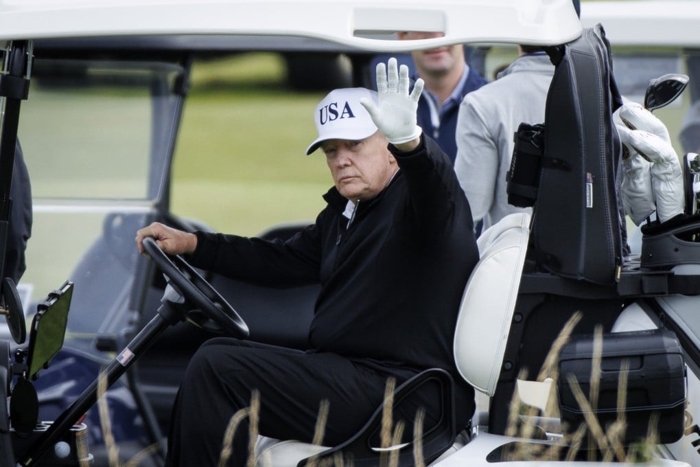 US President Donald Trump waves as he plays at Trump Turnberry golf course in Scotland on Saturday. Photo: EPA