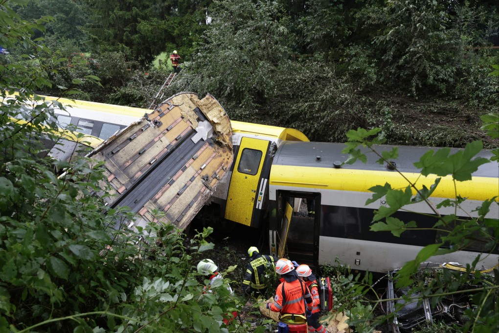 Rescuers search for passengers in a derailed train on Sunday in Biberach district, between Zweifaltendorf and Zell in south-western Germany. Photo: dpa