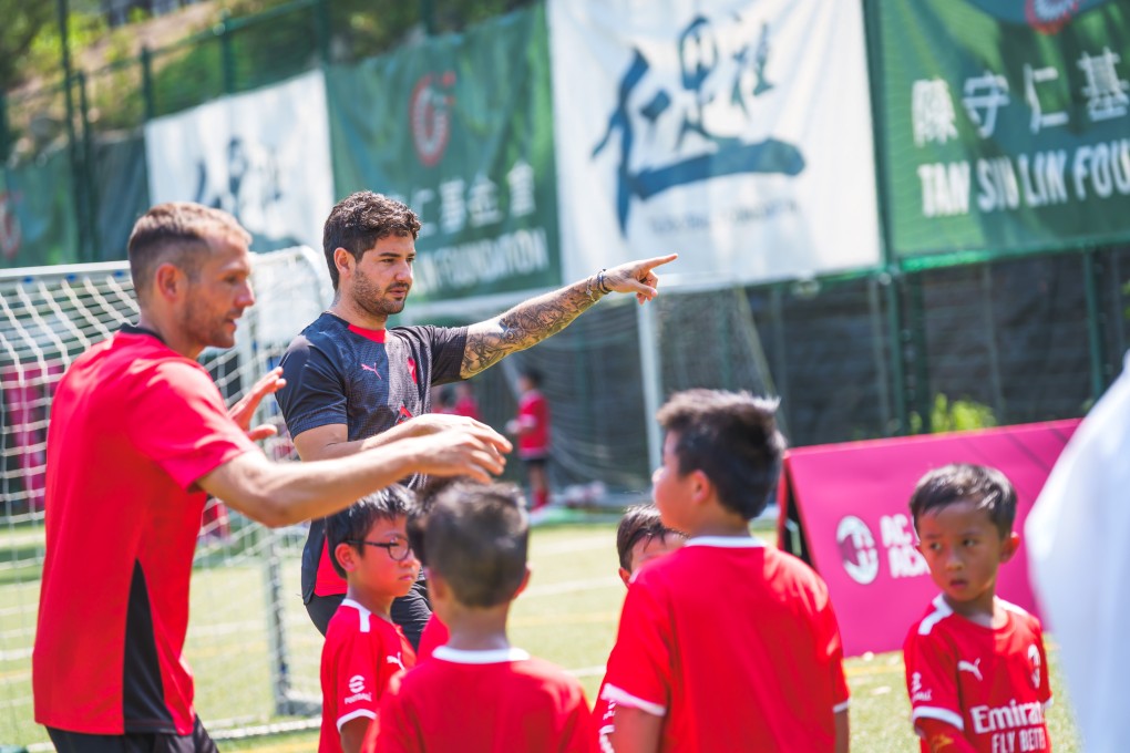 Andrea Galbiati (left) and Alexandre Pato give instructions to the children at AC Milan’s academy in Hong Kong. Photo: Handout