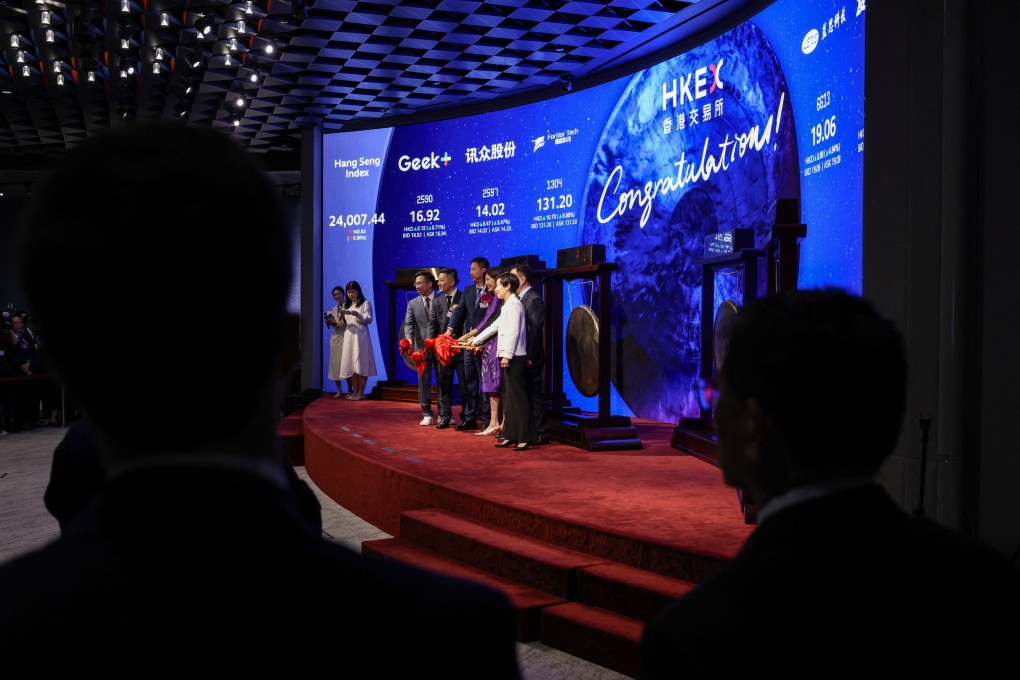 People pose for photos at Hong Kong’s stock exchange. Photo: Reuters