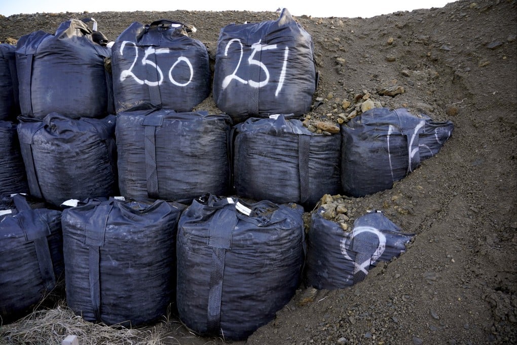 Bags containing contaminated debris are covered with soil in Namie, Fukushima prefecture, Japan in 2021. Photo: EPA-EFE