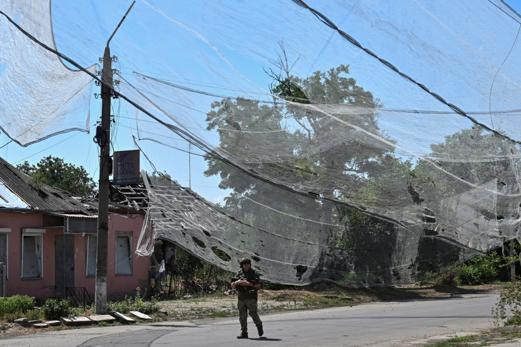 A Ukrainian soldier walks on a street protected with anti-drone nets in Ukraine’s frontline town of Orikhiv in Zaporizhzhia region on Wednesday. Photo: Reuters