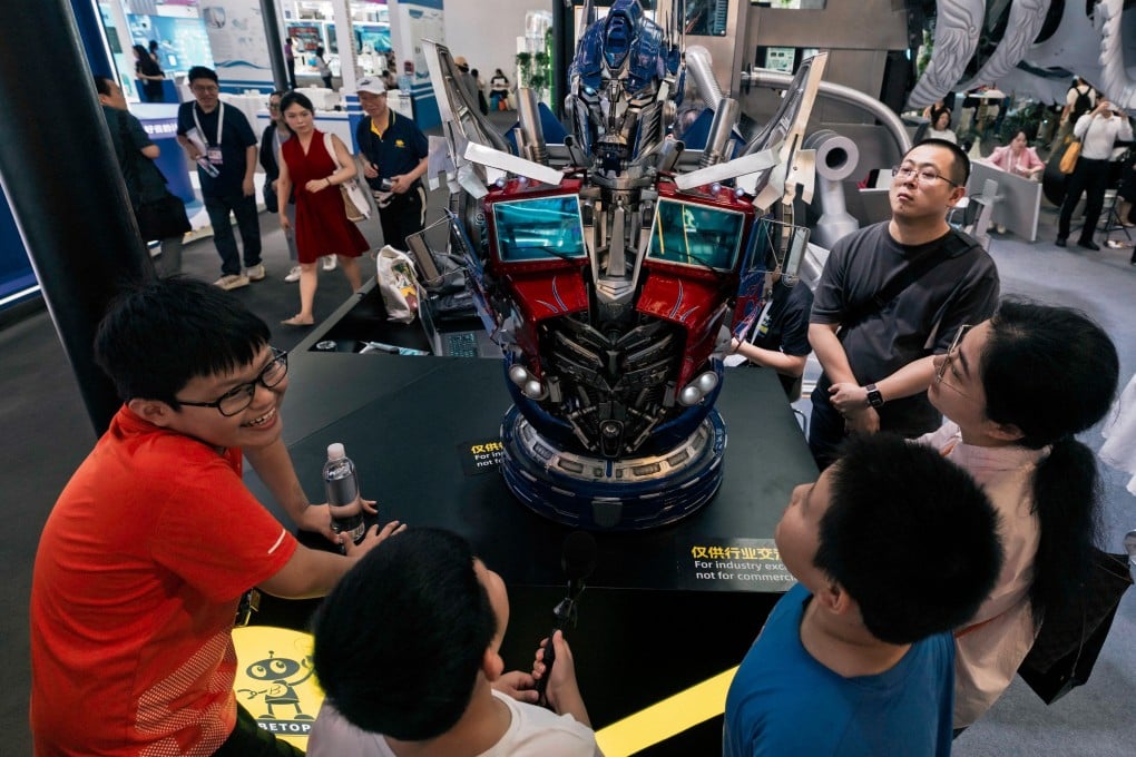 Visitors talk with an artificial intelligence-powered robot on display at the World Artificial Intelligence Conference in Shanghai on Monday. Photo: EPA