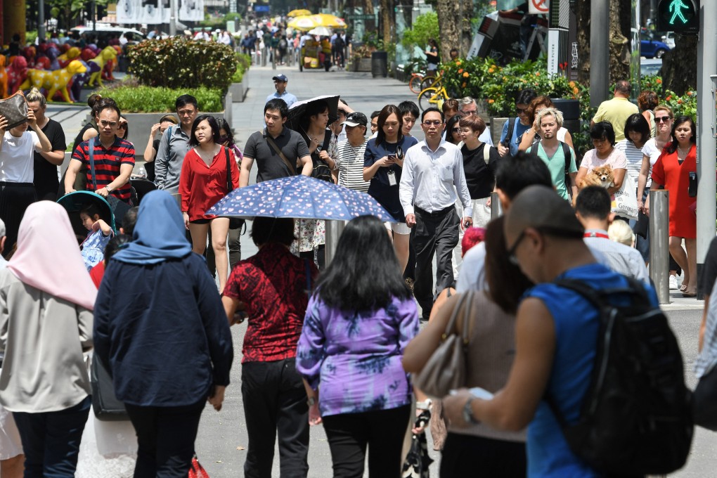 People walking along Orchard Road. A survey was conducted last year to assess the responses of Singaporeans of different ethnicities on the idea of “Chinese privilege”. Photo: AFP