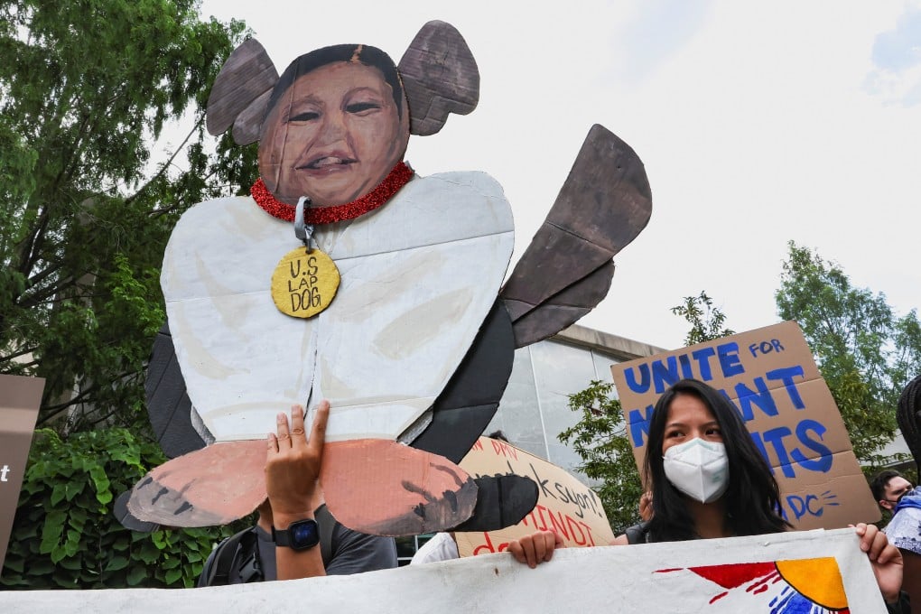 An activist holds up a cardboard cutout depicting Philippine President Ferdinand Marcos Jnr’s face with the body of a dog during a demonstration in front of the US Department of State in Washington on Monday. Photo: Reuters