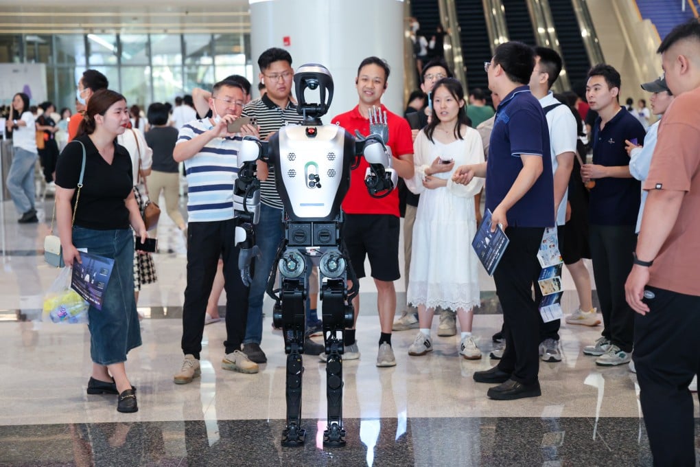 Visitors interact with a robot during the 2025 Guangdong-Hong Kong-Macao Greater Bay Area International Auto Show in Shenzhen, May 31, 2025. Photo: Xinhua