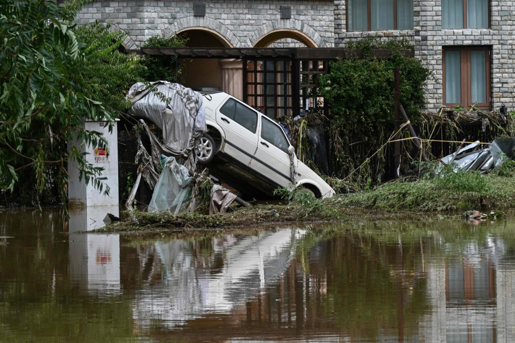 A damaged car is seen in a flooded neighbourhood in Miyun district, on the outskirts of Beijing on Tuesday. Photo: AFP