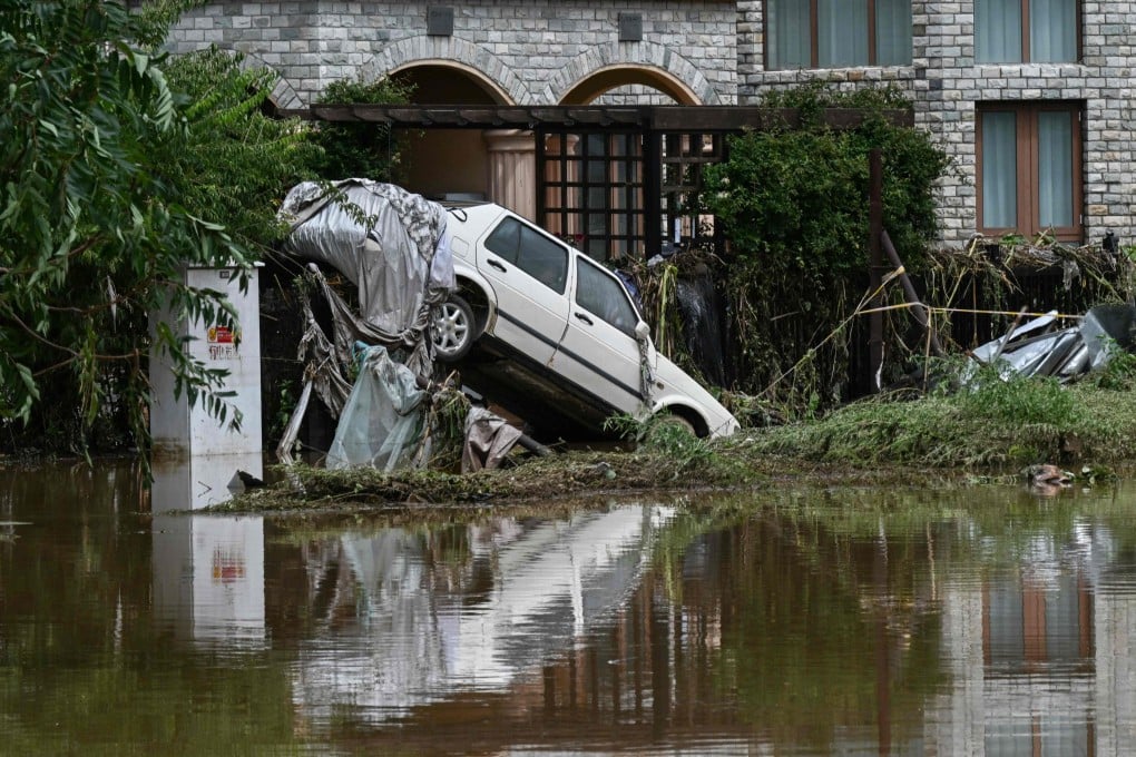 A damaged car is seen in a flooded neighbourhood in Miyun district, on the outskirts of Beijing on Tuesday. Photo: AFP