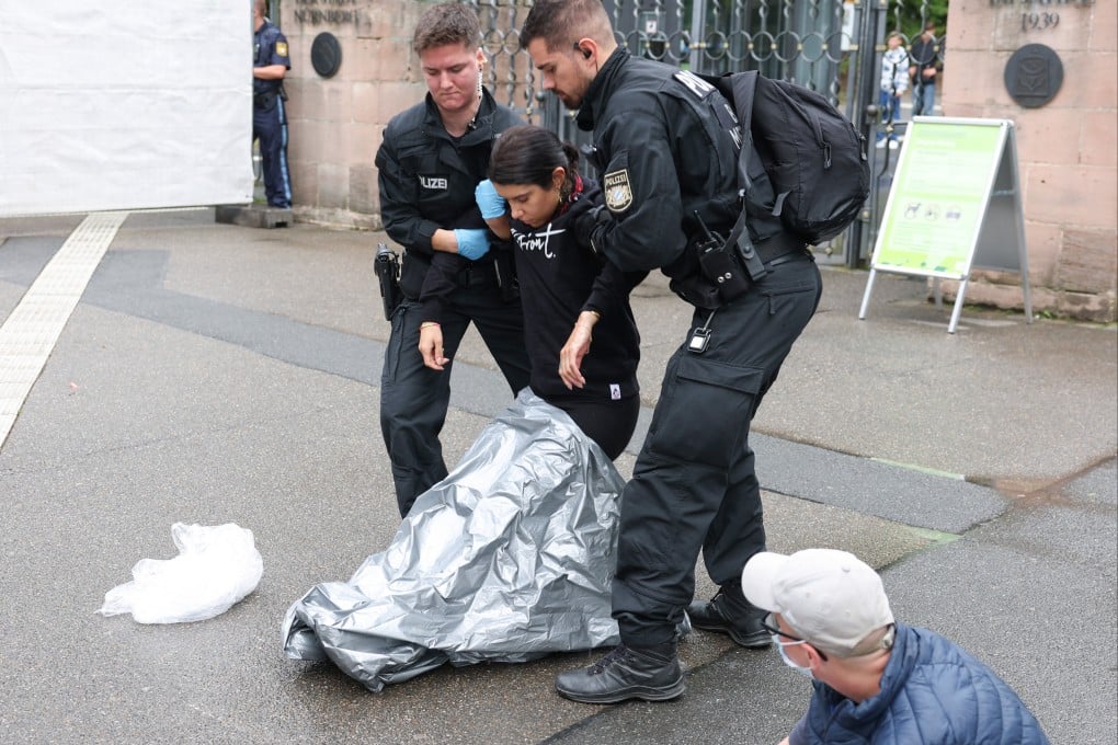 Police carry an activist to the side during a protest by activists against the planned killing of baboons, in front of Nuremberg Zoo in Nuremberg, Germany on Tuesday. Photo: dpa