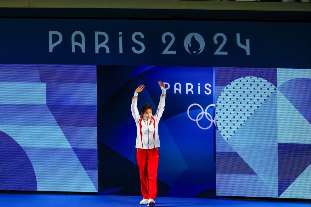 Quan Hongchan waves to the crowd ahead of the women’s 10m platform final at the Aquatics Centre in Paris. Photo: Getty Images
