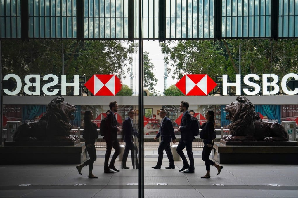 Office workers walk past lion statues outside HSBC’s main office building in Central. Photo: Elson Li