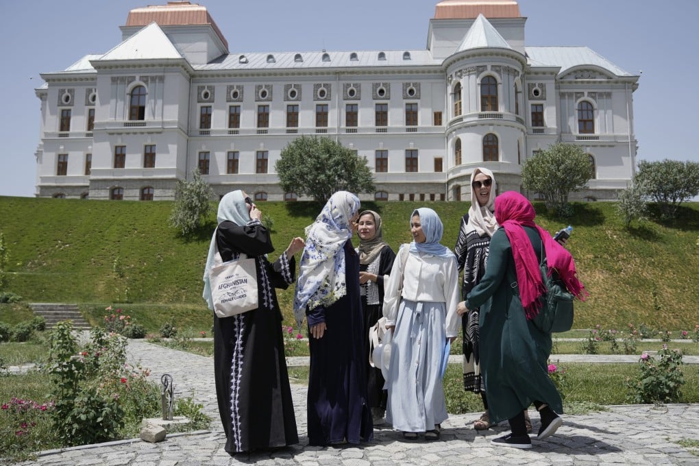 Three foreign tourists visit Darul Aman Palace accompanied by three female tour guides in Kabul, Afghanistan, on May 28. Photo: AP