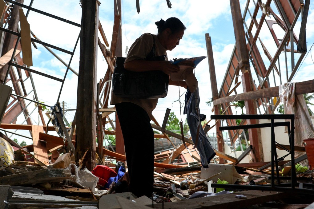 Koon Kantho collects items from her house after it was destroyed during Cambodia’s artillery attacks in Sisaket province, Thailand, on July 29. Photo: Reuters