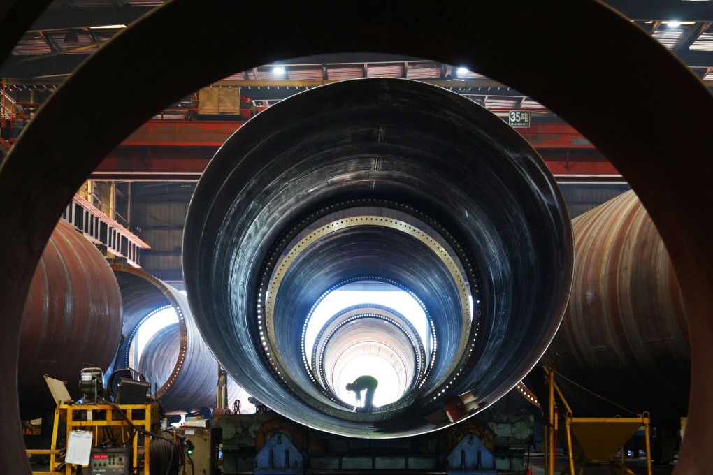 An employee works in a factory which produces wind turbine towers in eastern China. China’s factory activity unexpectedly fell to a six-month low in July as signs emerged of a softening in exports. Photo: AFP