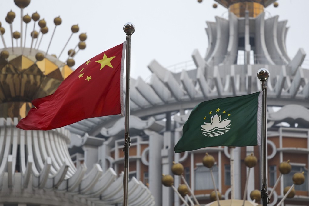 The Chinese national flag and Macau flag hoisted outside a building in Macau. Photo: Dickson Lee