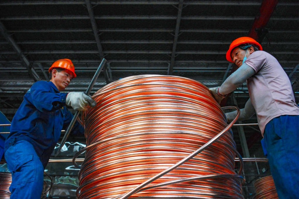 Employees wind copper rods at a workshop that recycles copper in China’s Anhui province on July 11. Photo: AFP