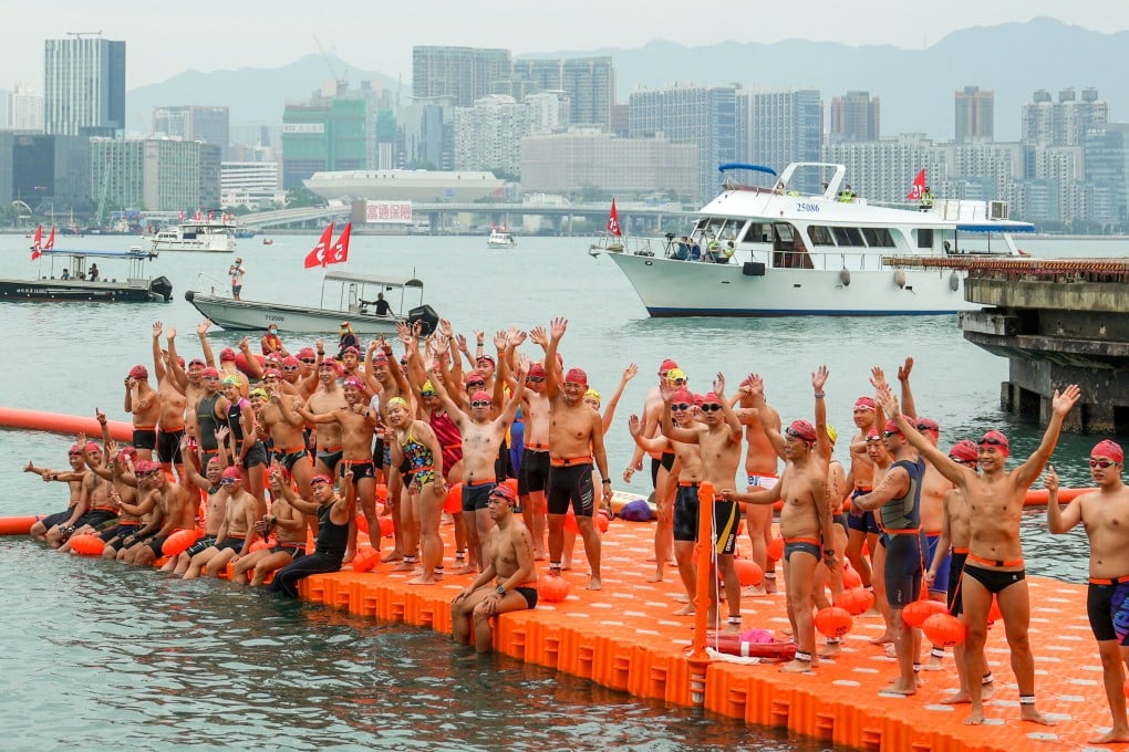 Swimmers line up at the starting point for the 2022 New World Harbour Race at Golden Bauhinia Square in Wan Chai. Photo: Sam Tsang