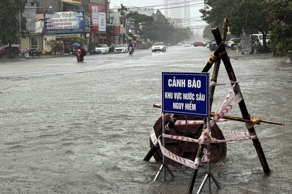 A warning sign of a deep water area at a flooded street in Thanh Hoa, Vietnam, on July 22 as Typhoon Wipha hits Asia. Photo: EPA