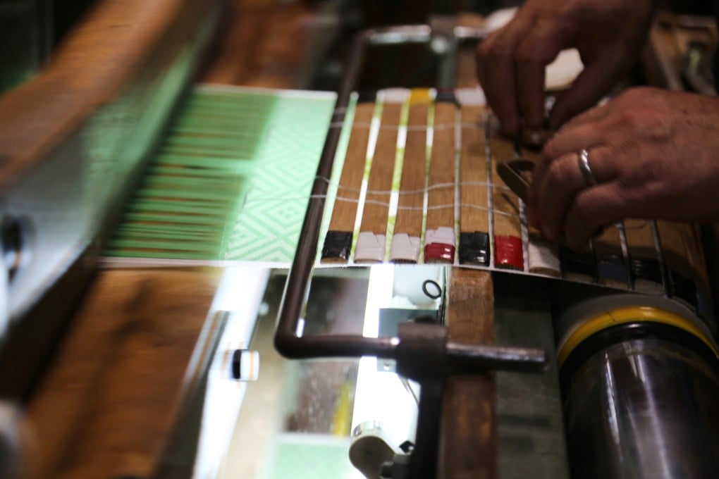 Hironori Fukuoka, the fourth-generation successor to his Nishijin-ori business, works on a fabric that is a collaboration with AI, in Kyoto, Japan on July 3, 2025. AI is undergoing trials as a design tool in the ancient art of weaving fabrics for kimonos in Kyoto. Photo: AP