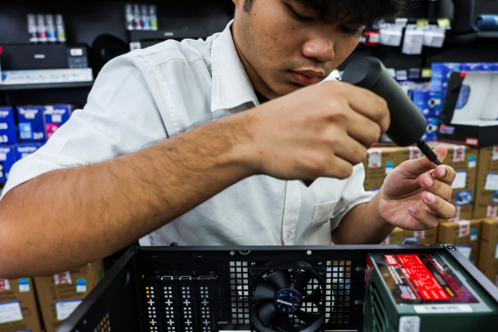 A man builds a custom PC for a customer at an IT store in Bangkok. US President Donald Trump has announce a 19 per cent tariff on goods from Thailand. Photo: Reuters