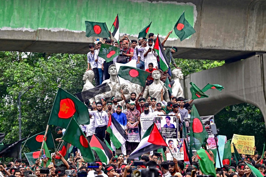 Demonstrators wave Bangladesh’s national flag during a rally in Dhaka last September marking one month since the ousting of the country’s former prime minister Sheikh Hasina. Photo: AFP