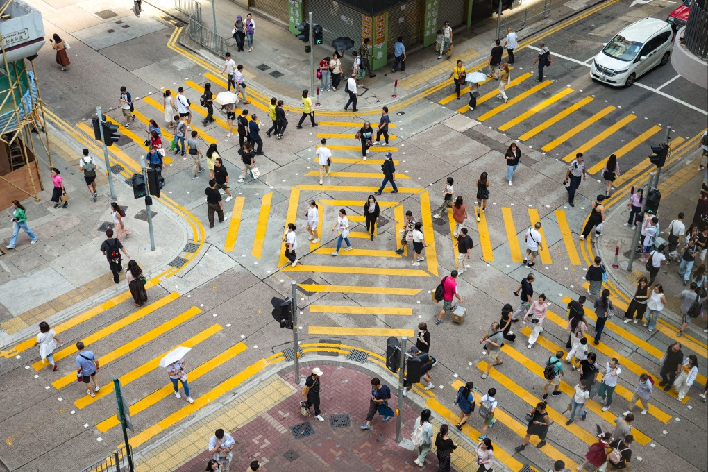Pedestrians cross a street in Kowloon. Photo: Sam Tsang