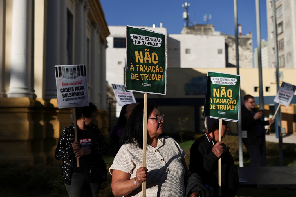 A protester holds a sign in Portuguese reading “No to Trump’s taxation” during a protest against the tariffs on Brazilian products imposed by US President Donald Trump, in Brazil on Tuesday. Photo: Reuters
