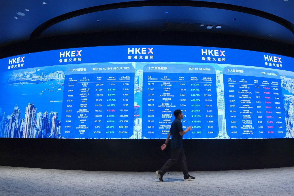 A person walks past an electronic display board at the Hong Kong Stock Exchange, on May 25. Photo: Xinhua