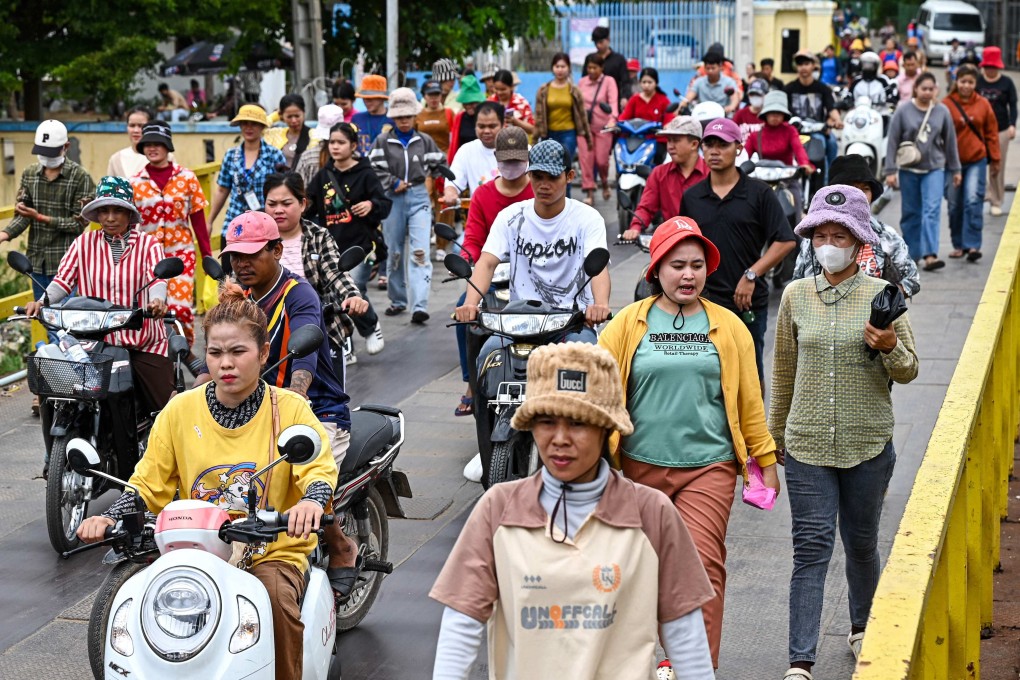 Garment workers walk out of their factory during their lunch break in Phnom Penh, Cambodia, on July 8. Trump threatened steep tariffs on the country, finally agreeing on 19 per cent. Photo: AFP